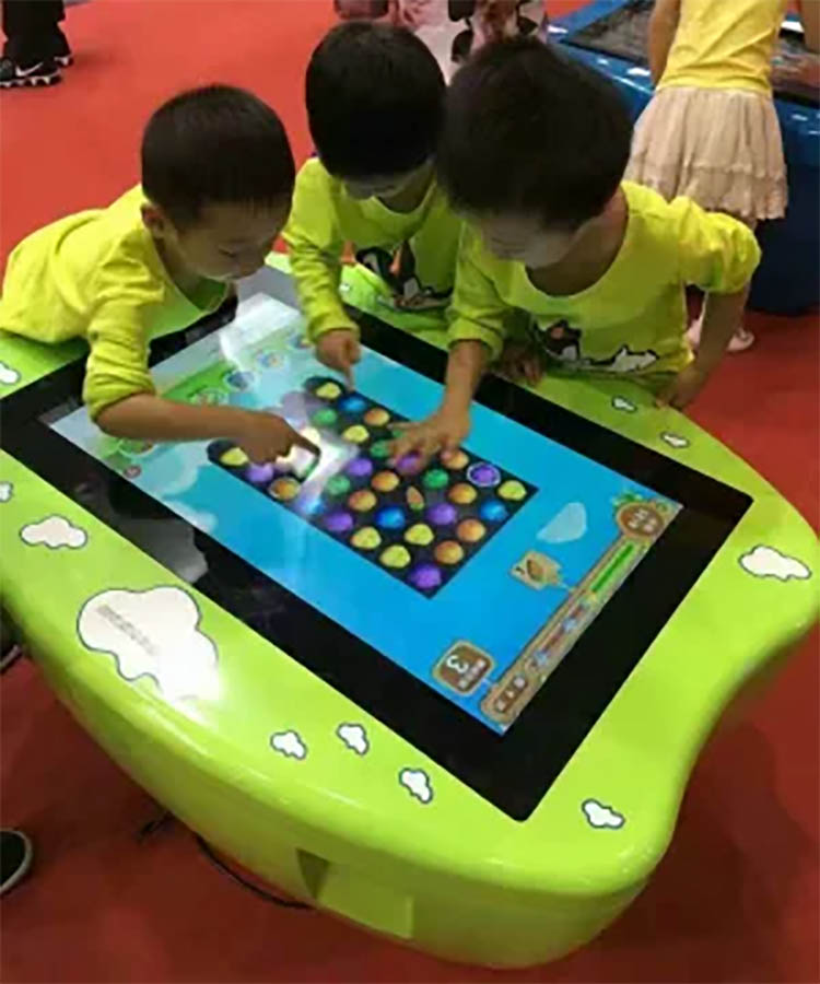 children using a multi-touch table for collaborative learning